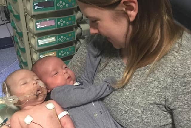 Ned with his mum, Nikki, and twin brother Gus, while he was in hospital