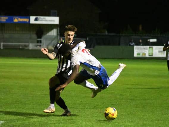 Callum Westwood tangles with AFC Rushden & Diamonds winger Ben Acquaye during Corby Town's Challenge Cup defeat at Hayden Road. Picture courtesy of HawkinsImages
