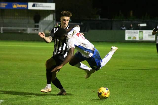 Callum Westwood tangles with AFC Rushden & Diamonds winger Ben Acquaye during Corby Town's Challenge Cup defeat at Hayden Road. Picture courtesy of HawkinsImages