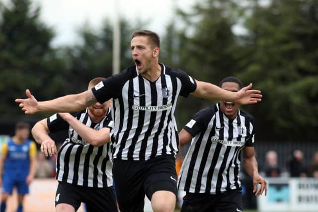 Charlie Wise shows his delight after he opened the scoring in Corby Town's 2-0 win over Biggleswade at Steel Park. Pictures by Alison Bagley
