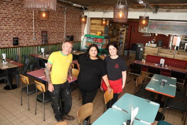 Matt, Emma and waitress Karlina Feldmanis