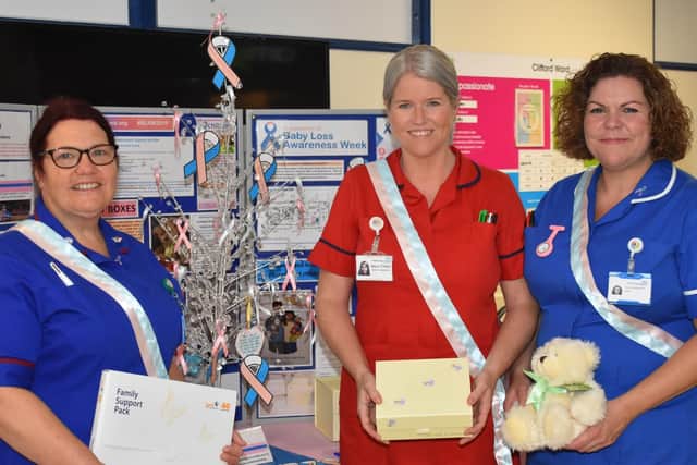 Stephanie Fretter, Bereavement Midwife, Mara Tonks, Head of Midwifery and Carolyn Rowbotham, Bereavement Midwife, with their display promoting Baby Loss Awareness Week 2019 in KGH