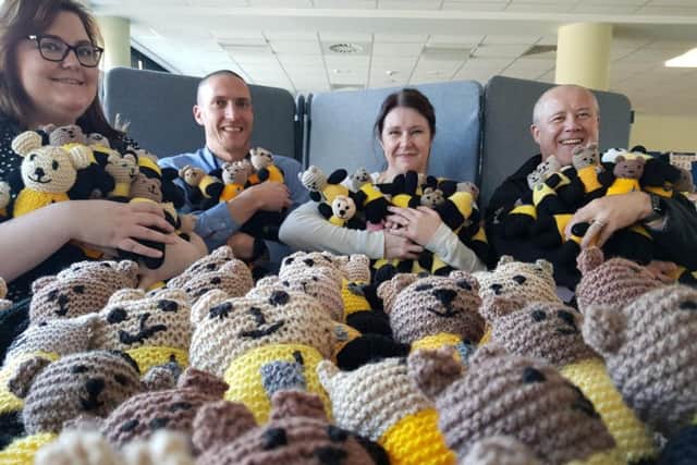 Detective Sergeant Jen Castle, Northamptonshire police, fire and crime commissioner Stephen Mold and two other officers with just some of the Bobby Buddies donated to Northamptonshire Police