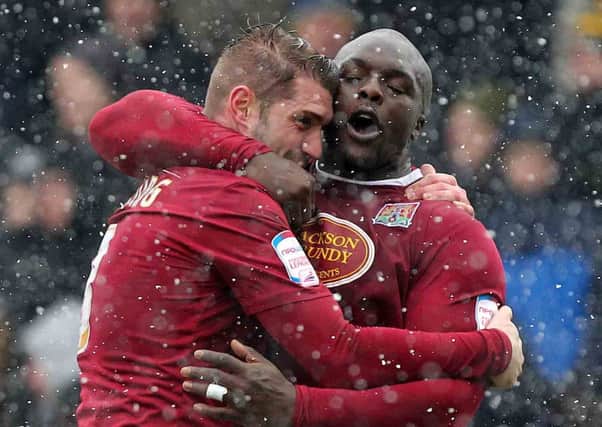 GOAL-DEN GUY - Ben Harding is congratulated by Adebayo Akinfenwa after scoring the only goal of the game at Sixfields (Picture: Sharon Lucey)