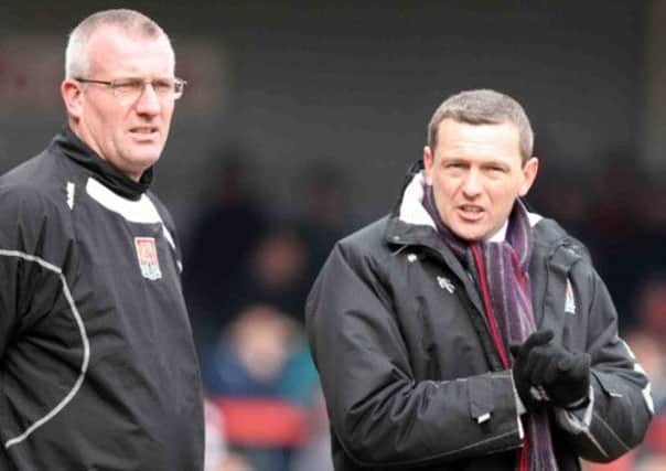 Tim Flowers and Aidy Boothroyd take in the Cobblers' 1-0 defeat at Cheltenham (pictures: Kirsty Edmonds)