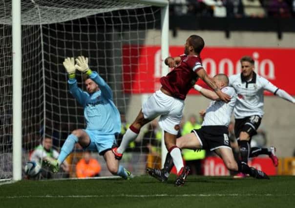 EARLY GOAL - Clarke Carlisle puts the Cobblers ahead at Vale Park (pictures: Kelly Cooper)