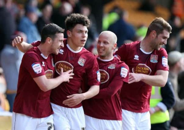 ROY'S THE BOY - Cobblers celebrate Roy O'Donovan's superb strike at Port Vale (pictures: Kelly Cooper)