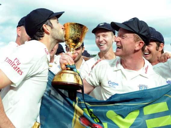 Durham captain Paul Collingwood (right) holds the trophy as Graham Onions kisses it after winning the LV= County Championship Division One at the Emirates Durham ICG, Chester-Le-Street. PRESS ASSOCIATION Photo. Picture date: Thursday September 19, 2013. See PA story CRICKET Durham. Photo credit should read: Owen Humphreys/PA Wire