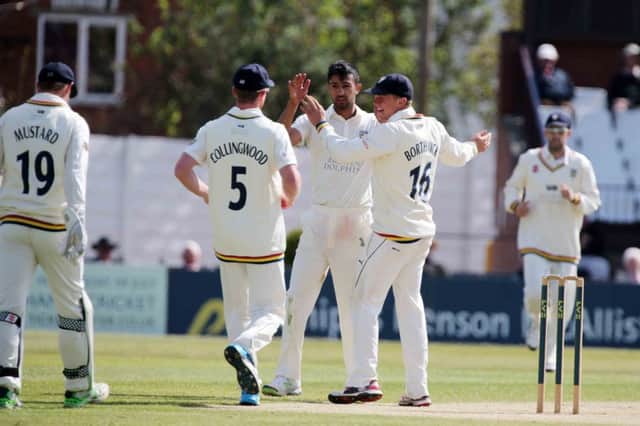 Durham's Usman Arshad is congratulated after taking the wicket of James Middlebrook
