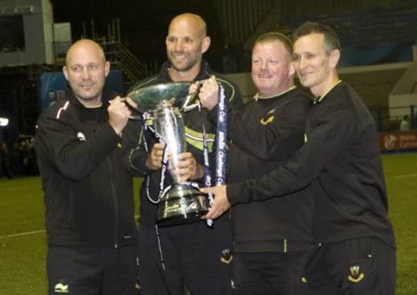 DOUBLE DELIGHT - Saints coaches Alex King, Jim Mallinder, Dorian West and Alan Dickens with the Amlin Challenge Cup (picture: Linda Dawson)