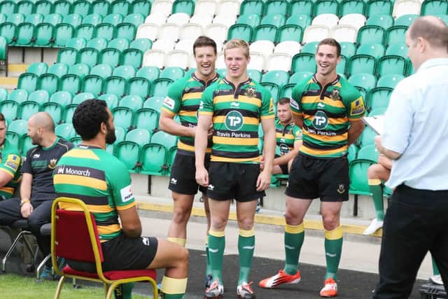 SMILE PLEASE - Glenn Dickson, Will Hooley and George North look on as Kahn Fotuali'i has his picture taken during Saints media day at Franklin's Gardens yesterday (Picture: Kirsty Edmonds)