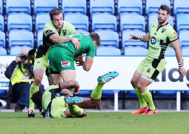 SOLID STUFF - Stephen Myler and Courtney Lawes team up to make a tackle in the win over London Irish  (Picture: Kirsty Edmonds)
