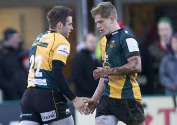 HANDING OVER - Will Hooley (right) gets his Saints chance with Stephen Myler with the England squad