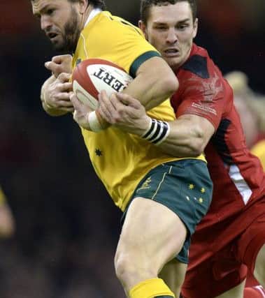 Australia's Adam Ashley-Cooper is tackled by Wales' George North during the Dove Men Series match at the Millennium Stadium, Cardiff. PRESS  ASSOCIATION Photo. Picture date: Saturday November 8, 2014. See PA story RUGBYU Wales. Photo credit should read: Andrew Matthews/PA Wire. RESTRICTIONS: Use subject to restrictions. Editorial use only. Strictly no commercial use. No use in books without prior written permission from WRU. Call +44 (0)1158 447447 for further information. NNL-141113-112623002