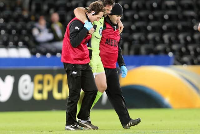 WORRYING SIGHT - Ben Foden is helped from the pitch at the Liberty Stadium after suffering a knee injury (Picture: Kirsty Edmonds)