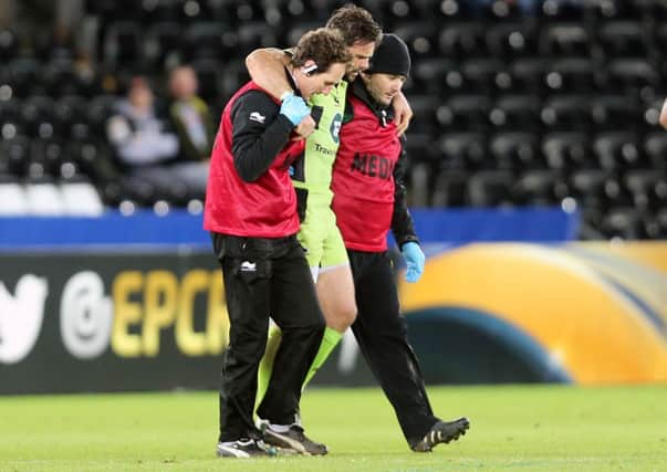 WORRYING SIGHT - Ben Foden is helped from the pitch at the Liberty Stadium after suffering a knee injury (Picture: Kirsty Edmonds)