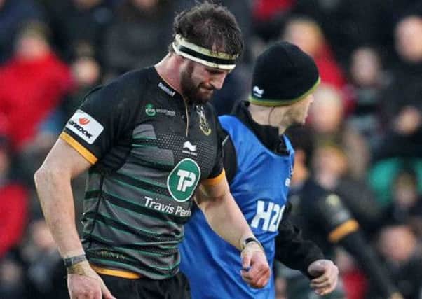 INJURY BLOW - Tom Wood leaves the Franklin's Gardens pitch on Saturday due to a hamstring injury (Picture: Sharon Lucey)