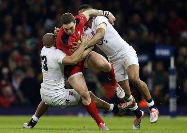 George North is tackled by England's Anthony Watson and Jonathan Joseph during the Six Nations opener at the Millennium Stadium on Friday night
