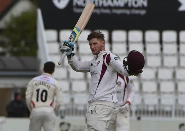 Rob Keogh acknowledges the applause having reached a century for Northamptonshire against Lancashire. Picture by Dave Ikin