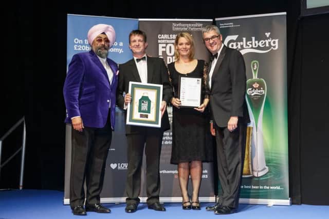 Phil and Amanda Saxby receive their winning trophy, flanked by special guest Hardeep Singh Kohli and Bruce Ray from Carlsberg UK