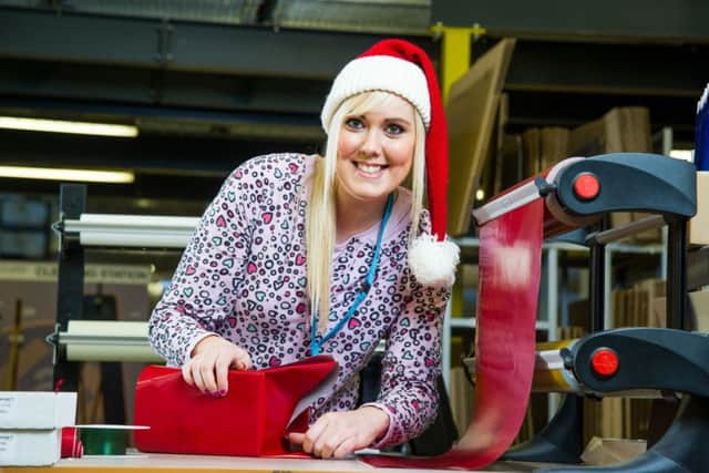 Amazon gift wrapper Cheryl Wilson. Amazon has recruited an army of 500 present wrappers - who will get through 300 MILES of gift wrap this Christmas. The UK's biggest online retailer has bought in 12,000 rolls of decorative ribbon - which would stretch for 700 miles if laid out - and 16 MILLION gift tags. Bosses reckon their 500 specially-trained wrapping recruits will use more than 50 square miles of red and silver gift wrap. If laid out flat, the rolls of wrapping paper would stretch from London to Newcastle. Photo: SWNS