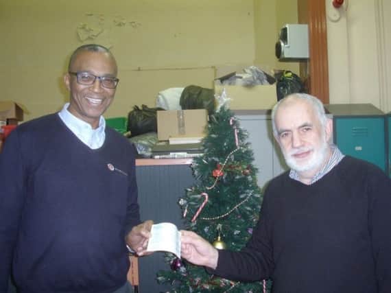 Paul Chambers (right) of the Daylight Centre, receives a cheque from Sam Chambers, of York Ward and Rowlett