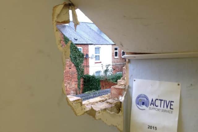 The smashed wall at the care service