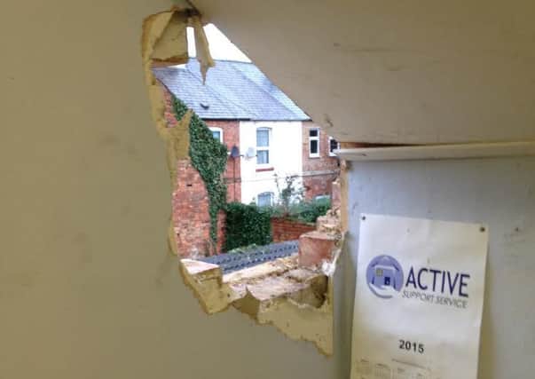The smashed wall at the care service
