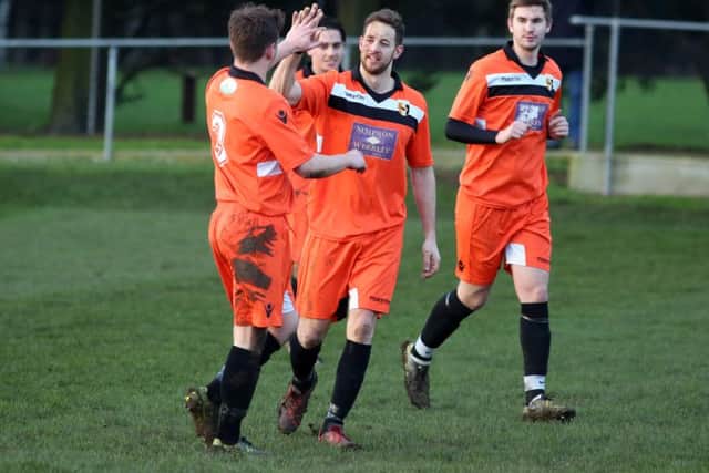 Jack Dyson celebrates after scoring his first and Rushden & Higham United's second goal in the 4-1 win over Bugbrooke. Pictures by Alison Bagley