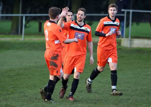 Jack Dyson celebrates after scoring his first and Rushden & Higham United's second goal in the 4-1 win over Bugbrooke. Pictures by Alison Bagley