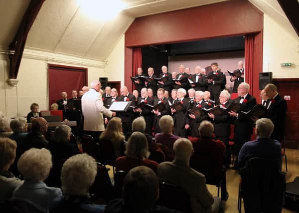 The Corby Male Voice Choir performing at a concert in Geddington.