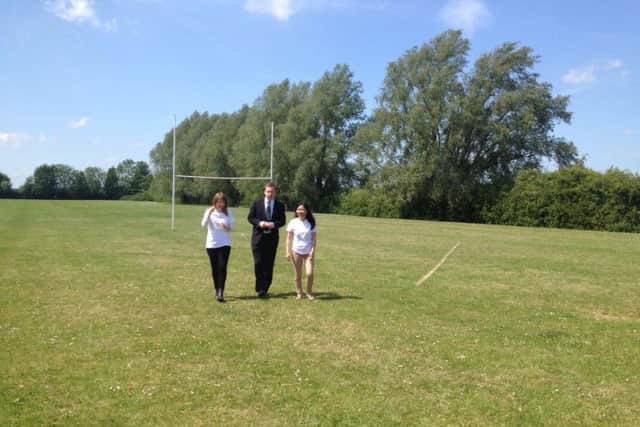 Tom Pursglove with Jo Trott and Julie Grove at the school playing field in Oundle last year