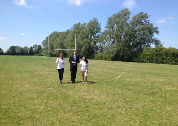 Tom Pursglove with Jo Trott and Julie Grove at the school playing field in Oundle last year