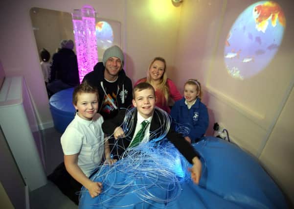 Jordan with his family in the sensory room in Studfall Infants School. 
Dad Colin with mum Jacqueline, Jordan's brother Kyle Hutchison , eight, and sister Lacey Hutchison, seven