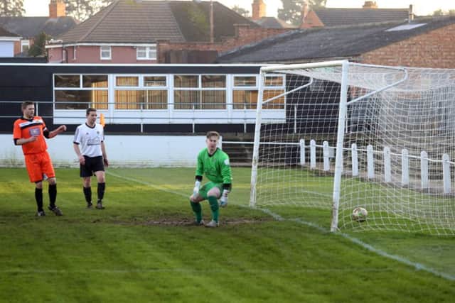 Jon Tite's deflected shot finds the net for Rushden & Higham's opening goal in last weekend's 4-1 victory over Bugbrooke. The Lankies host fellow high-fliers Stewarts & Lloyds tomorrow. Picture by Alison Bagley