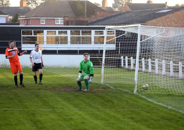 Jon Tite's deflected shot finds the net for Rushden & Higham's opening goal in last weekend's 4-1 victory over Bugbrooke. The Lankies host fellow high-fliers Stewarts & Lloyds tomorrow. Picture by Alison Bagley