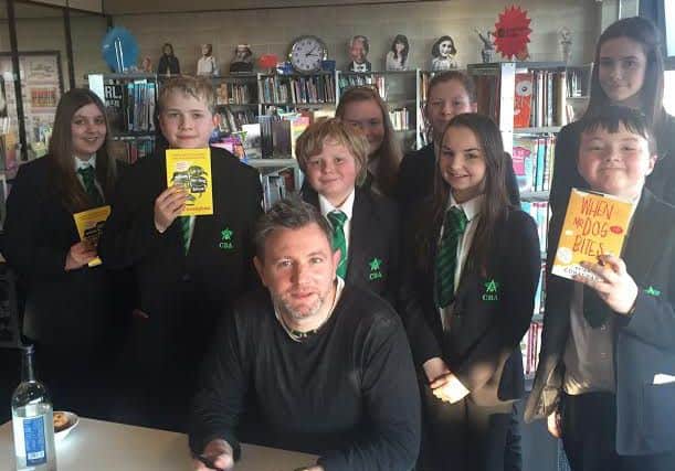 Author Brian Conaghan with a group of Corby Business Academy students