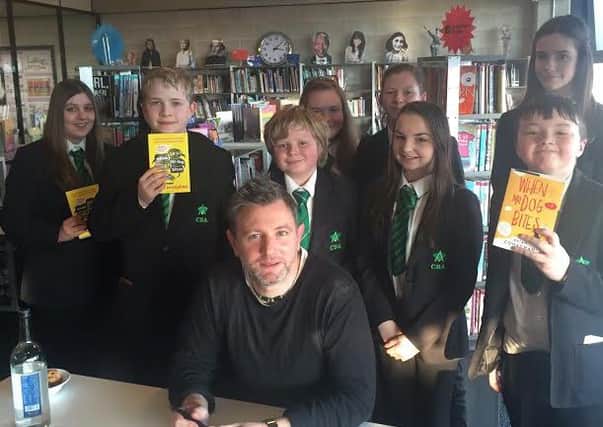 Author Brian Conaghan with a group of Corby Business Academy students