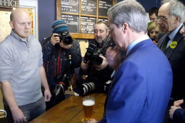 Farage has a pint in The Little Ale House. NNL-160123-175318001
