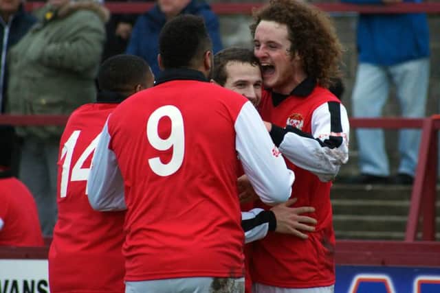 Liam Canavan takes the congratulations after he put Kettering Town 2-1 up at Weymouth. However, the Poppies were eventually beaten 3-2. Picture by Peter Short