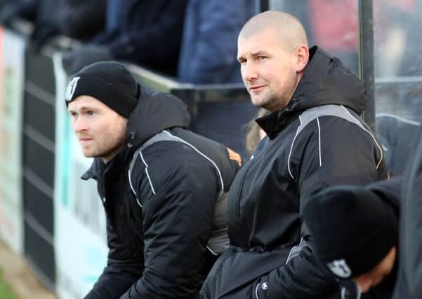 Corby Town assistant-manager David Clarke, pictured alongside boss Tommy Wright, has launched a successful online auction to help raise funds for fitness equipment in the cancer ward at Leicester's Royal Infirmary