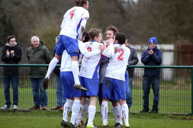 Andy Hall is mobbed by his AFC Rushden & Diamonds team-mates after opening the scoring in the 3-0 home win over Ware. Pictures by Alison Bagley