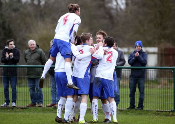 Andy Hall is mobbed by his AFC Rushden & Diamonds team-mates after opening the scoring in the 3-0 home win over Ware. Pictures by Alison Bagley