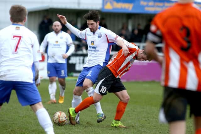 AFC Rushden & Diamonds midfielder Brad Harris battles for possession with Ware's Jimmy Hartley