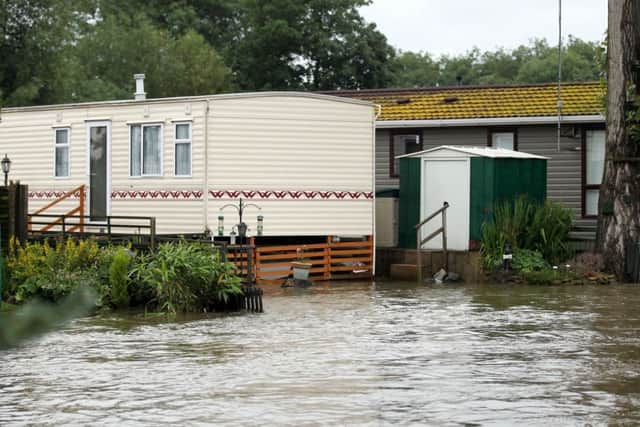 A photograph from 2012 shows the effects of flooding at Cogenhoe Mill caravan park. The site sits on the banks of the River Nene.