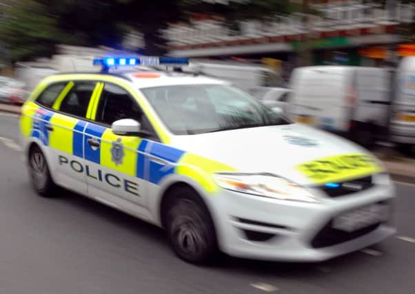 A man was knocked to the ground and robbed of his mobile phone by three men after being verbally abused in Kettering.