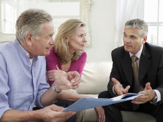 Retirees speaking with their financial advisor. Pic by Shutterstock