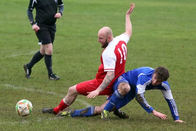 Action from Thrapston Town's 1-1 draw with Woodford United