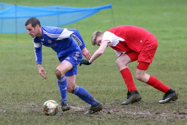 Action from Thrapston Town's 1-1 draw with Woodford United