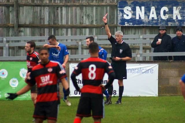 Chippenham's Matt Smith is shown the red card following his challenge on Chris Carruthers